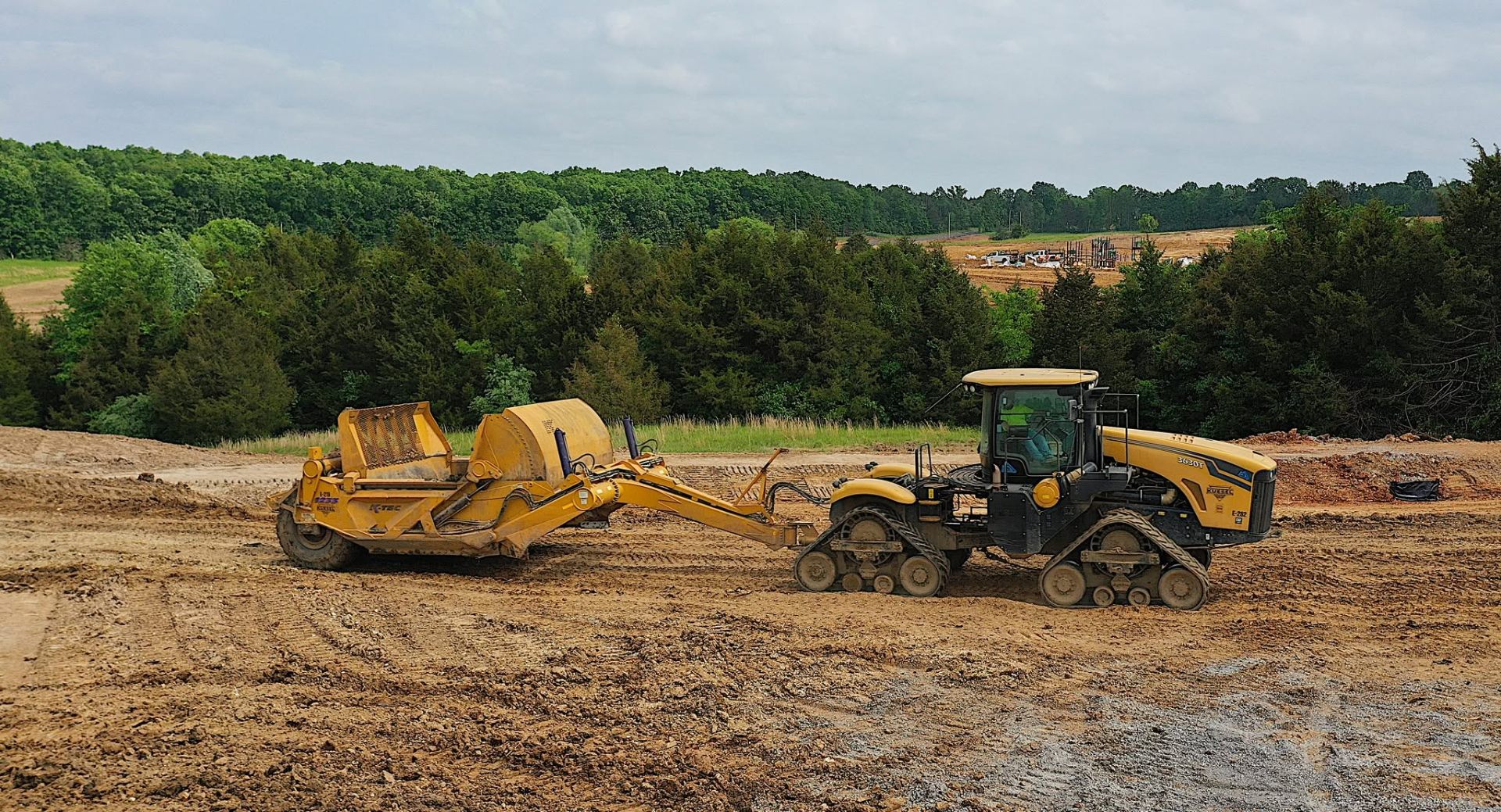 Scraper fleet moving material on a large-scale earthwork project