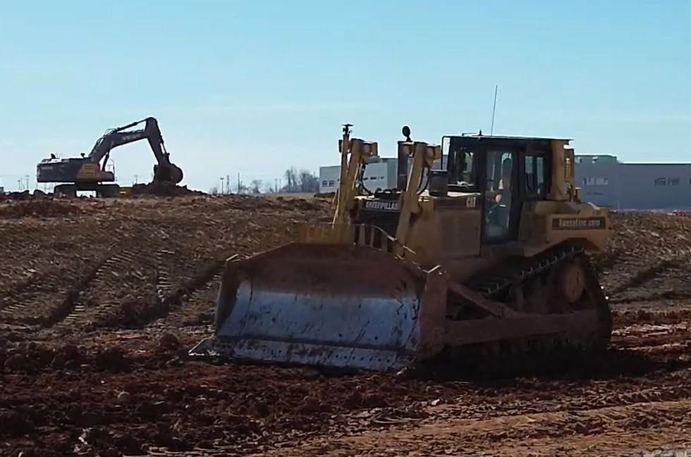 Precision site grading with dozer and excavator working in tandem