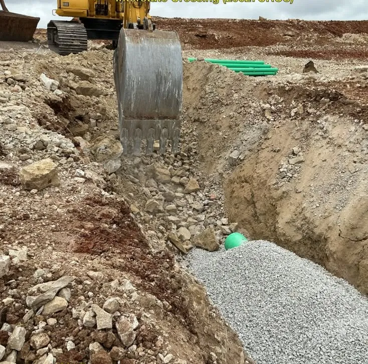 Utility trench with stone bedding ready for pipe