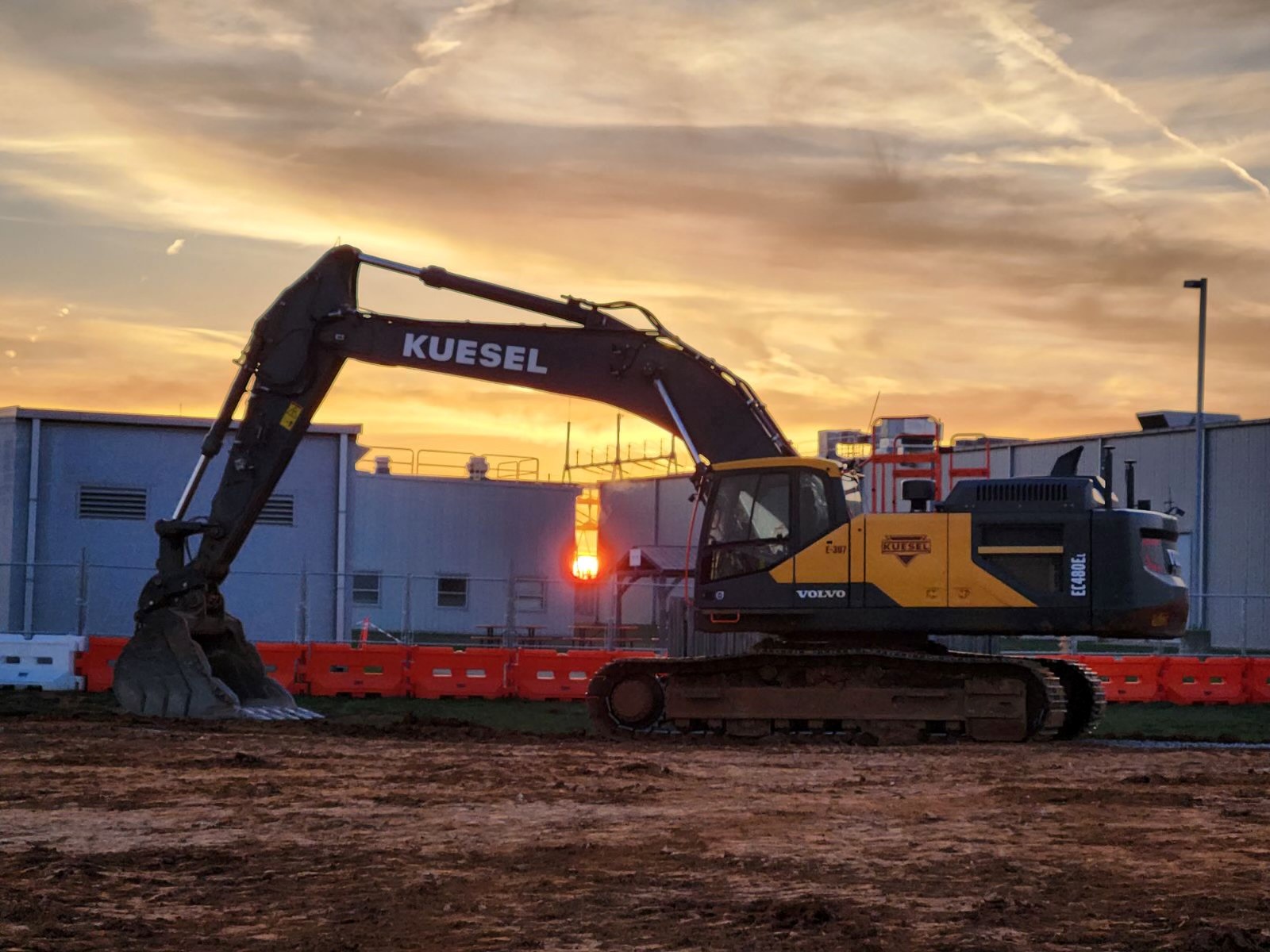 Hyperscale data center sitework at dusk — mass grading and underground utilities