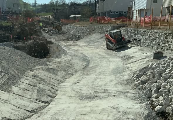 Channel rehabilitation with rip-rap and retaining wall — stormwater work