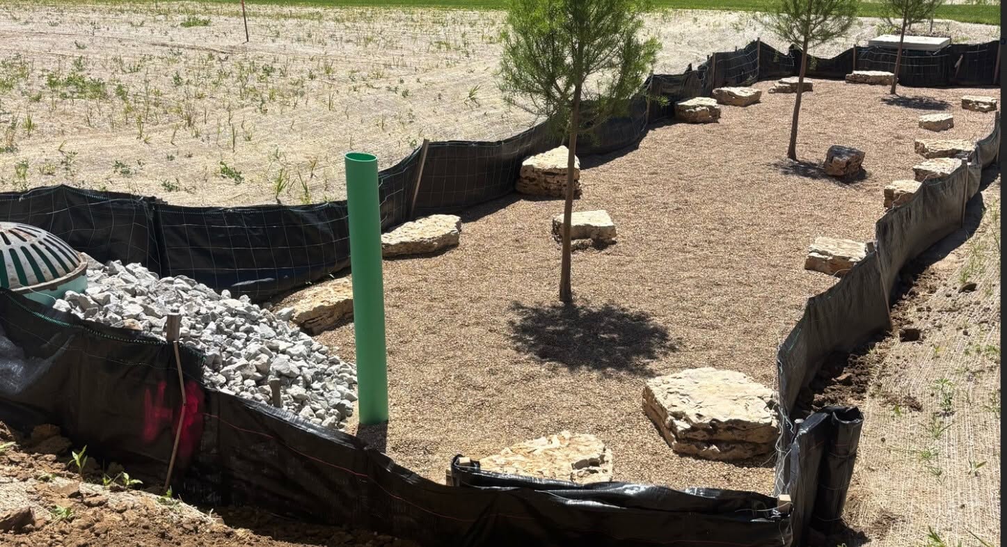 Completed bioretention basin with native planting, underdrain, and outlet structure